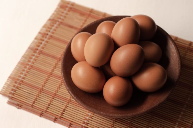 brown eggs on brown wooden bowl